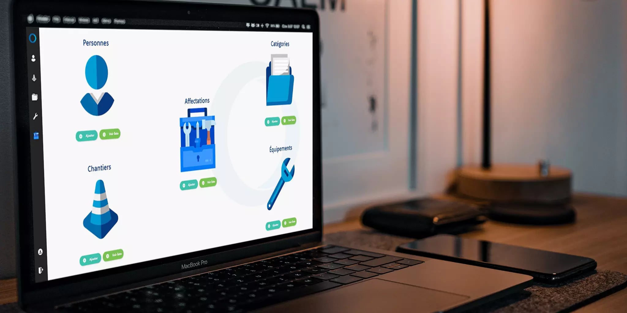 Laptop displaying a business management software interface with sections for personnel, categories, assignments, and equipment in an office setting.